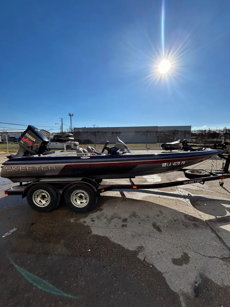 Slide: The Image of 2003 Skeeter SX 200 boat with a single seat and trolling motor. - 11