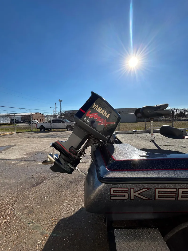 Slide: The Image of 2003 Skeeter SX 200 boat with trolling motor and control panel. - 12