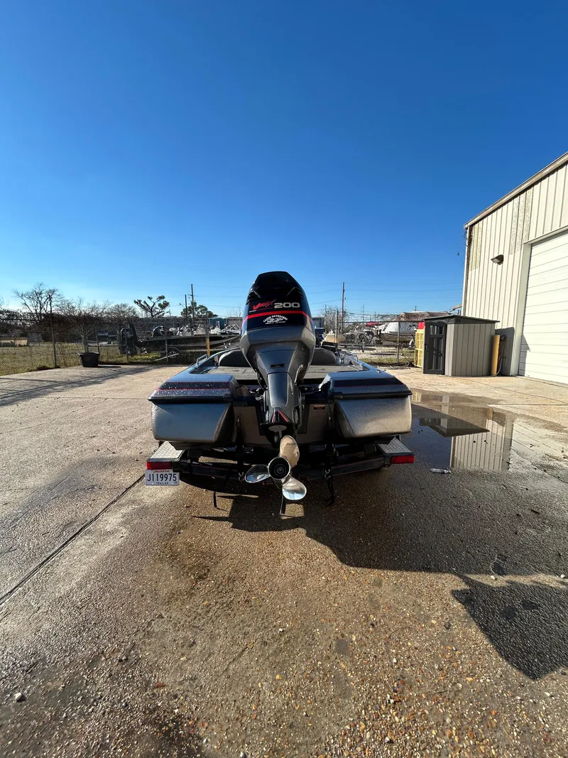 Slide: The Image of 2003 Skeeter SX 200 boat dashboard and controls in a marina. - 15