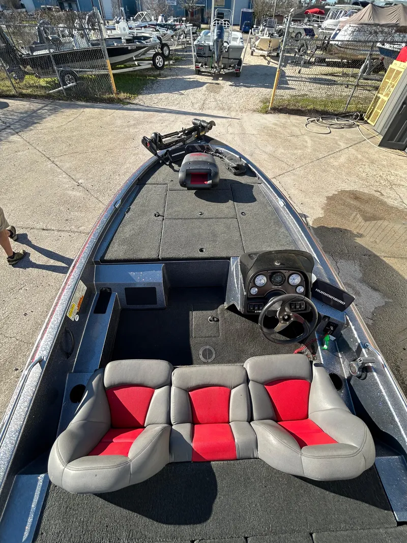 Slide: The Image of 2003 Skeeter SX 200 boat with an exposed outboard motor in a garage. - 20