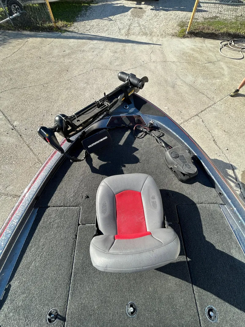 Slide: The Image of 2003 Skeeter SX 200 boat engine under maintenance in a sunny outdoor setting. - 21