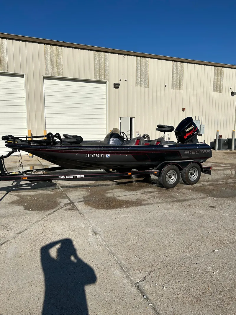 Slide: The Image of 2003 Skeeter SX 200 boat with Yamaha outboard motor on trailer. - 4