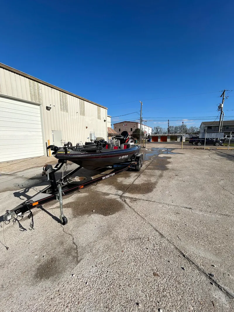 Slide: The Image of 2003 Skeeter SX 200 boat with Yamaha VMAX outboard motor in a parking lot. - 6