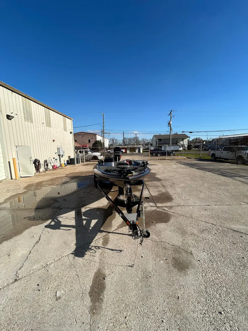 Slide: The Image of 2003 Skeeter SX 200 boat engine in a parking lot. - 8