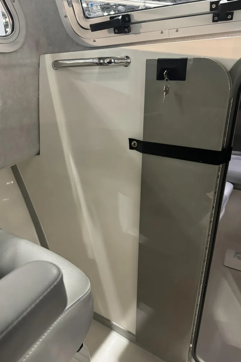 Slide: The Image of Interior of 2024 Defiance 260 Admiral EX boat with steering wheel and Garmin navigation system. - 19