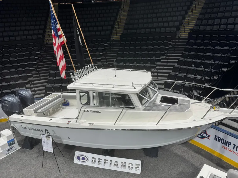Slide: The Image of 2024 Defiance 260 Admiral EX boat showcased at an indoor boat show. - 4