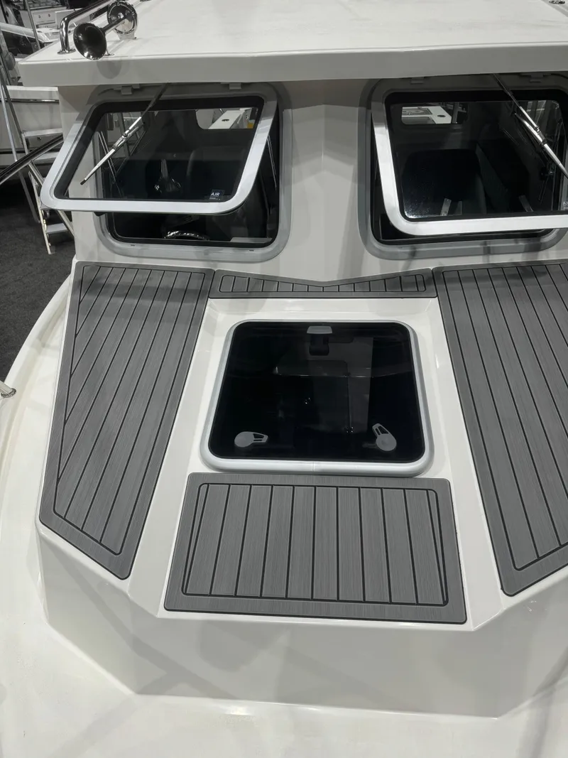 Slide: The Image of 2024 Defiance 260 Admiral EX boat deck with windows and non-slip surface. - 44
