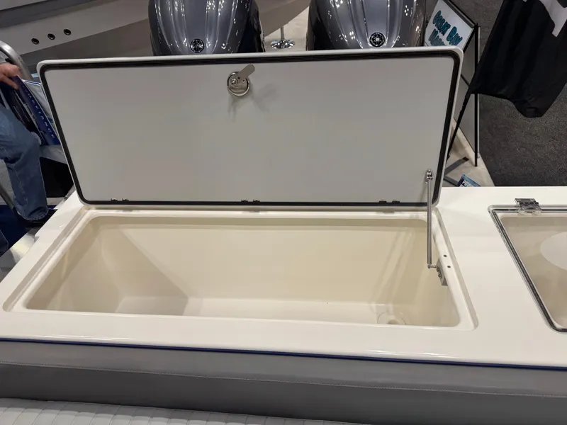 Slide: The Image of 2024 Defiance 260 Admiral EX storage compartment with open lid. - 10