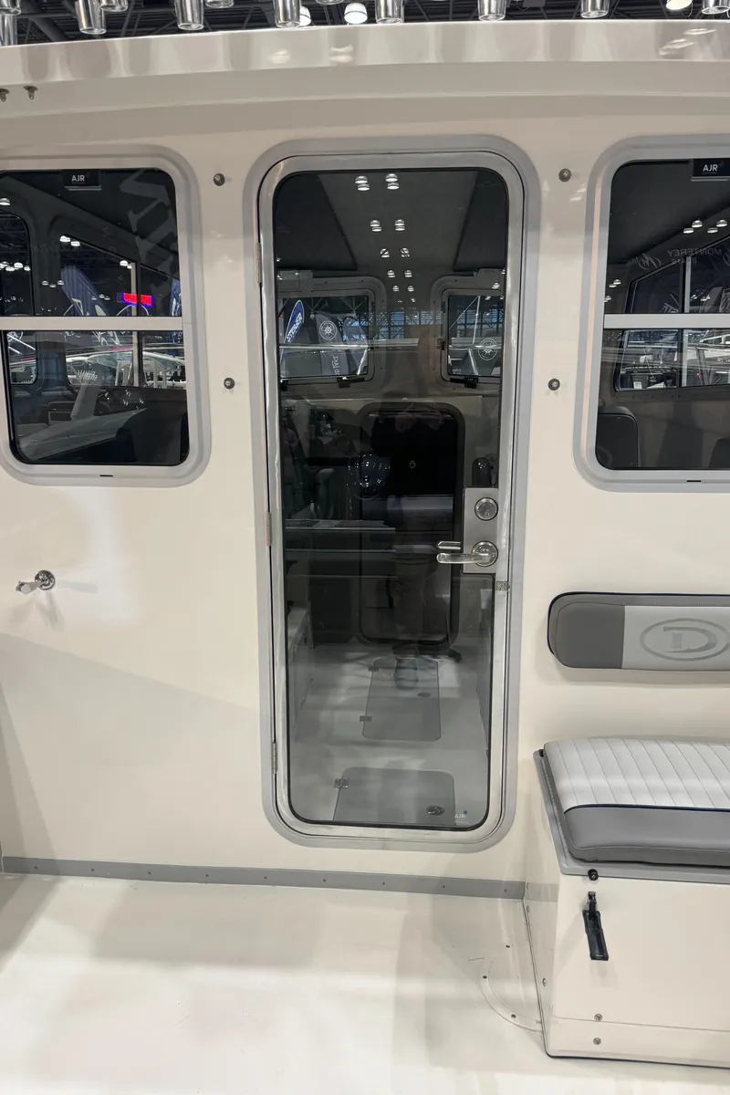 Slide: The Image of 2024 Defiance 260 Admiral EX boat interior with toilet and seating. - 17