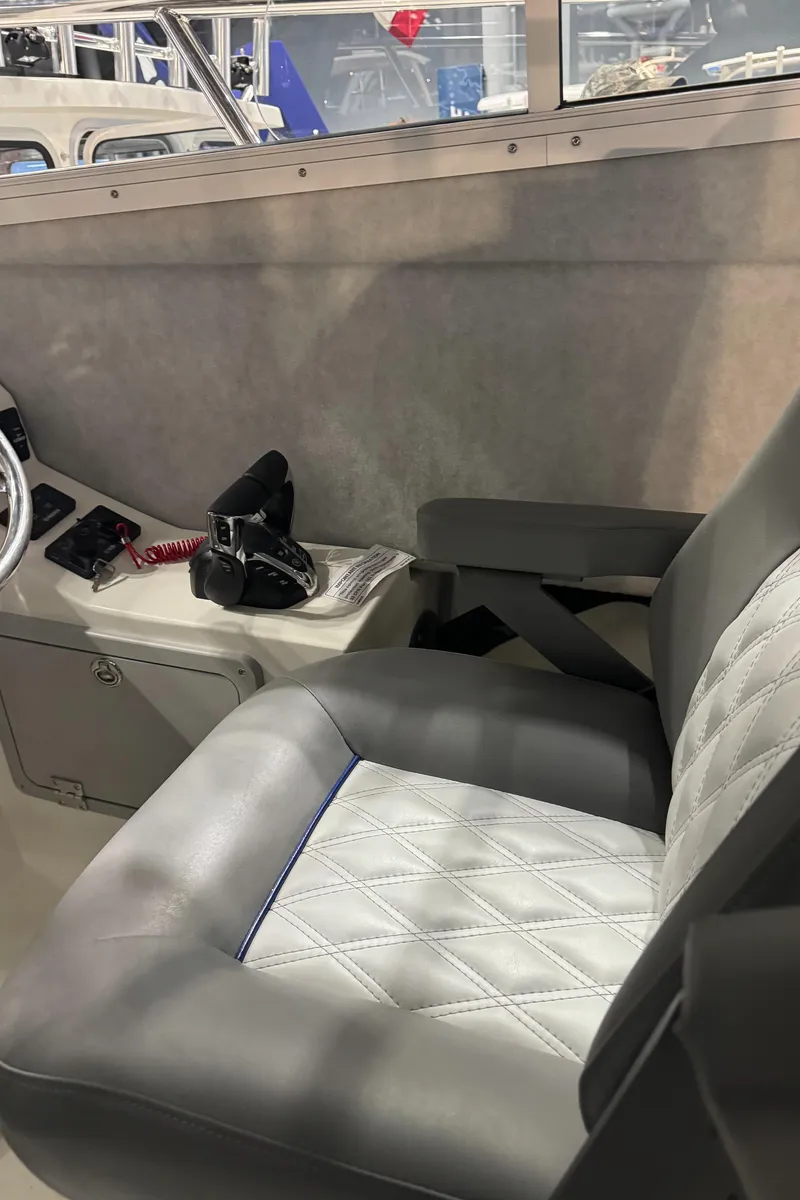 Slide: The Image of 2024 Defiance 260 Admiral EX interior seating with quilted upholstery. - 24