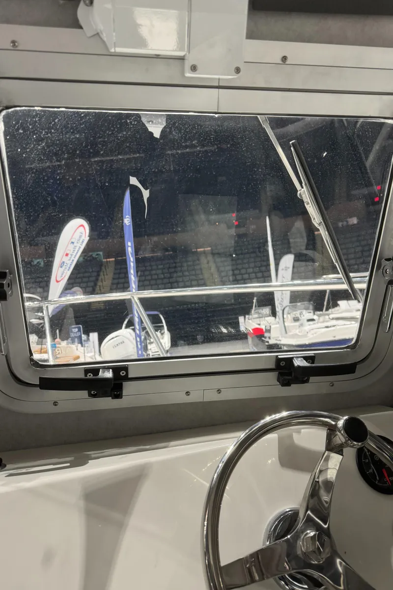 Slide: The Image of View from the helm of a 2024 Defiance 260 Admiral EX boat. - 42