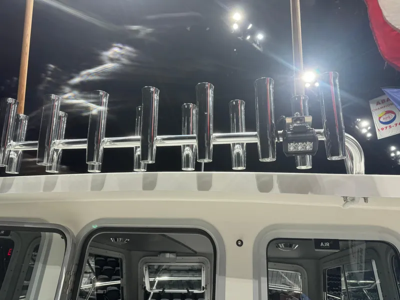 Slide: The Image of 2024 Defiance 260 Admiral EX boat with multiple rod holders on the roof. - 43