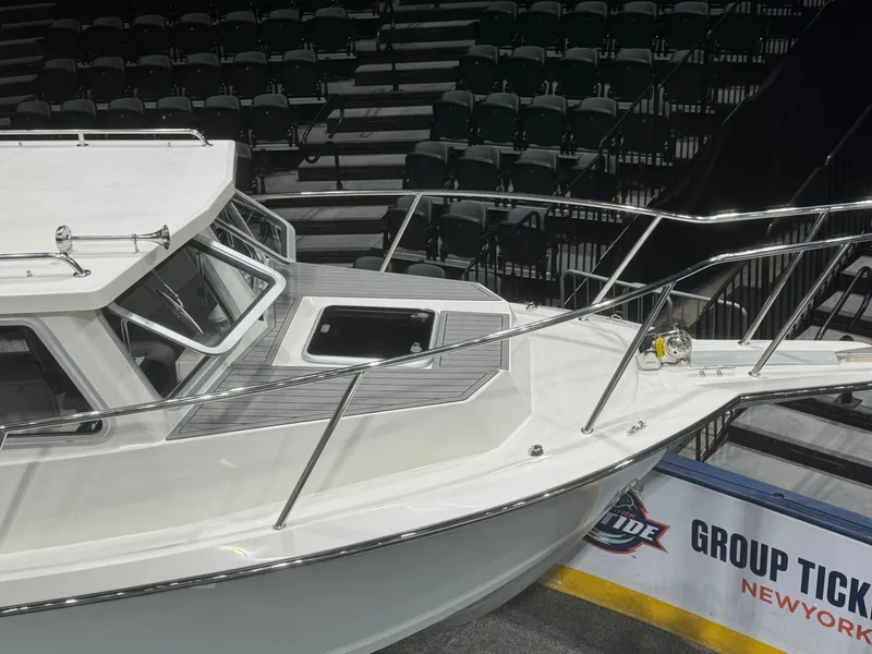 Slide: The Image of 2024 Defiance 260 Admiral EX boat front view at indoor exhibition. - 5