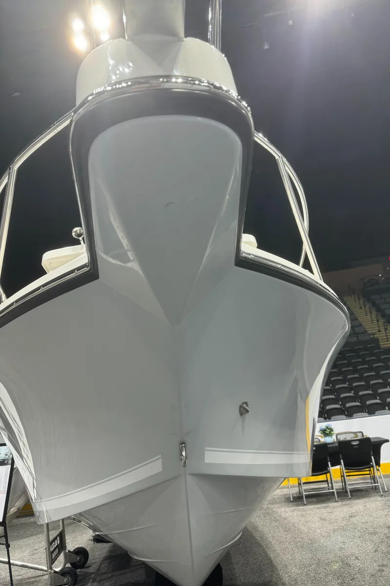 Slide: The Image of 2024 Defiance 260 Admiral EX boat with dual engines and cushioned seating. - 7