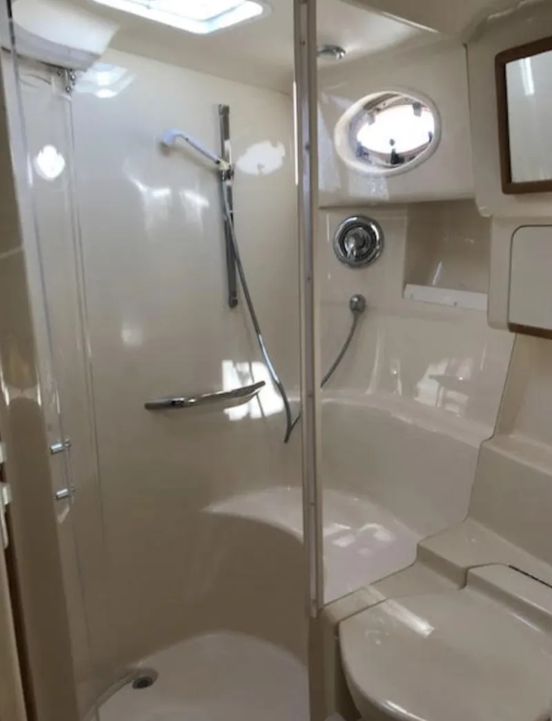 Slide: The Image of 1996 Sea Ray 450 Sundancer yacht bathroom with shower and porthole window. - 3
