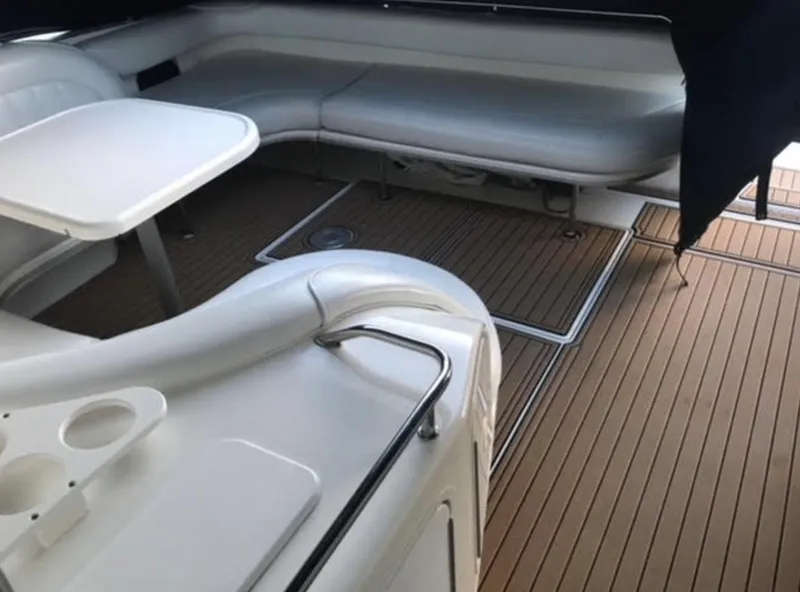 Slide: The Image of Interior seating area of a 1996 Sea Ray 450 Sundancer yacht with wooden flooring. - 5
