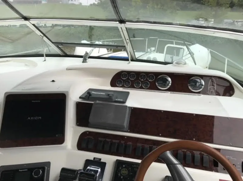 Slide: The Image of 1996 Sea Ray 450 Sundancer helm with navigation instruments and steering wheel. - 8