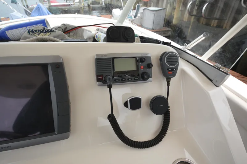 Slide: The Image of Control panel of a 2012 Pursuit 280 boat with radio and navigation equipment. - 14