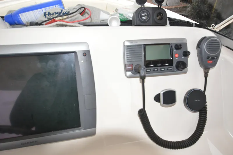 Slide: The Image of Control panel of a 2012 Pursuit 280 boat with Garmin GPS and radio equipment. - 16