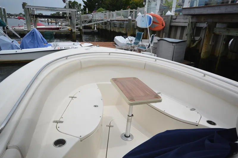 Slide: The Image of 2012 Pursuit 280 boat with bow seating and table at dock. - 18