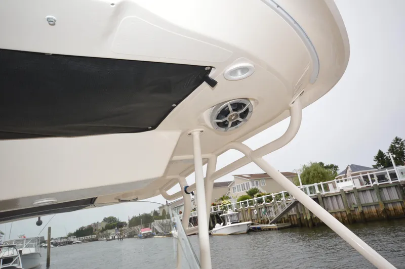 Slide: The Image of 2012 Pursuit 280 boat canopy and speaker system at a marina. - 22