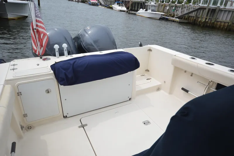 Slide: The Image of 2012 Pursuit 280 boat with twin engines docked at a marina. - 25