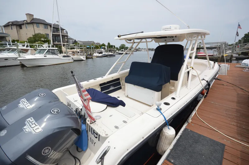 Slide: The Image of 2012 Pursuit 280 boat docked with twin Yamaha engines. - 28