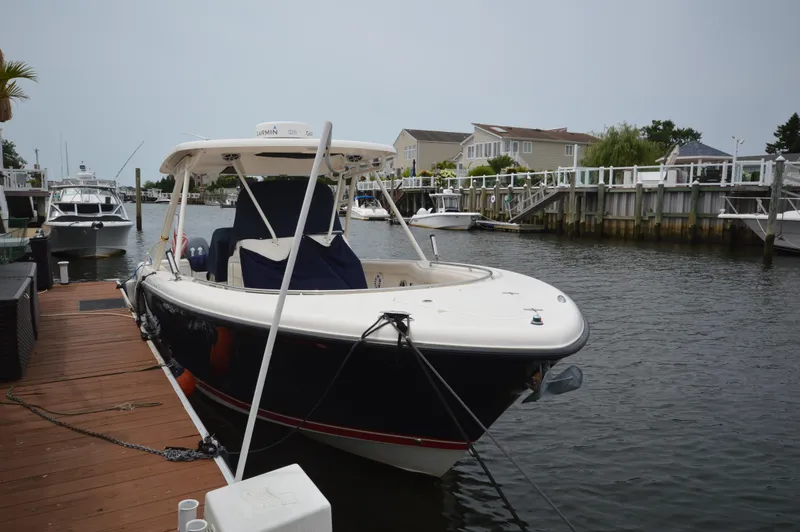 Slide: The Image of 2012 Pursuit 280 boat docked in a residential canal. - 3