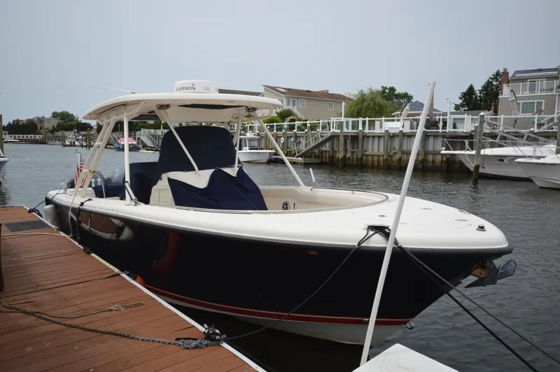 Slide: The Image of 2012 Pursuit 280 boat docked at a marina. - 4