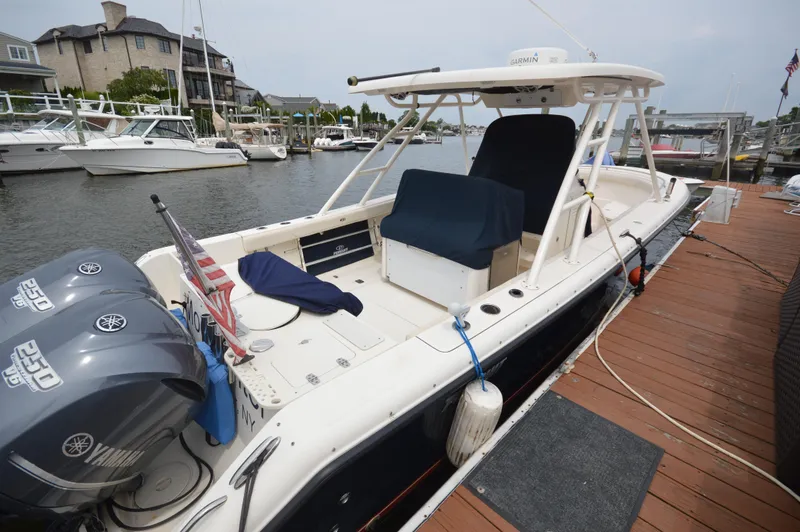 Slide: The Image of 2012 Pursuit 280 boat docked, featuring Yamaha engines and spacious seating. - 7