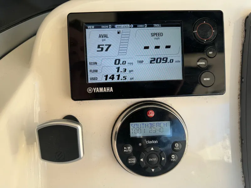 Slide: The Image of Yamaha display and Clarion audio system on a 2012 Pursuit 280 boat dashboard. - 8