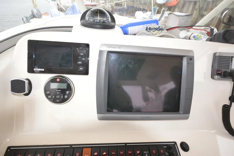 Slide: The Image of Control panel of a 2012 Pursuit 280 boat with navigation equipment. - 13