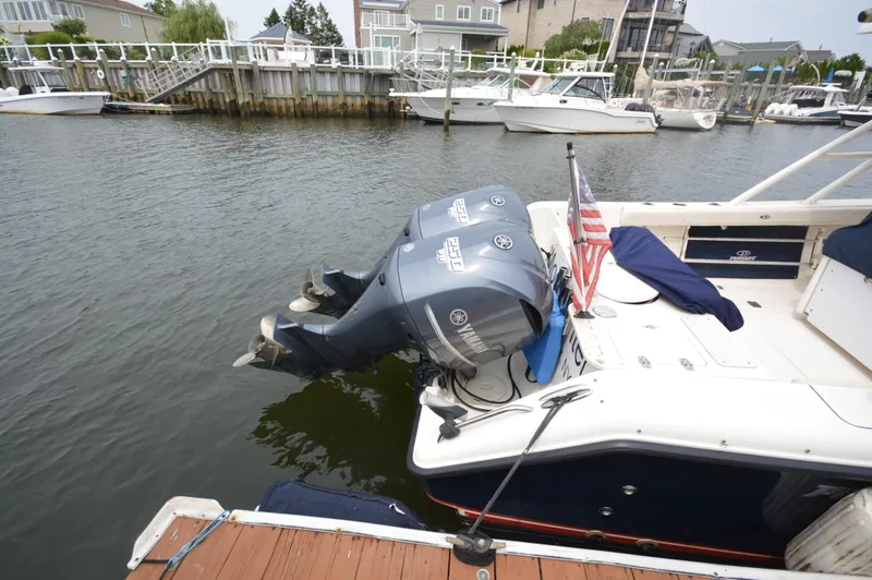 Slide: The Image of 2012 Pursuit 280 boat with twin outboard engines docked at a marina. - 6