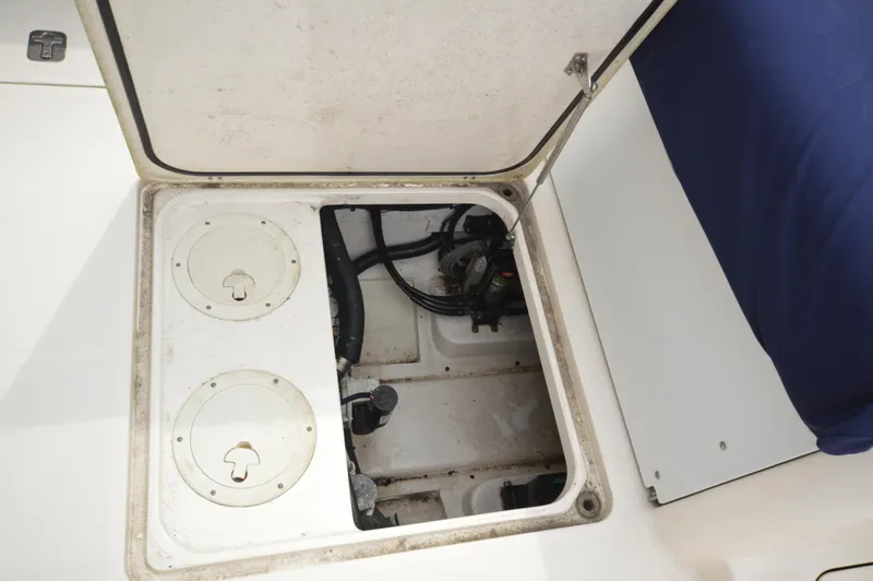 Slide: The Image of 2012 Pursuit 280 boat storage compartment with open hatch. - 9