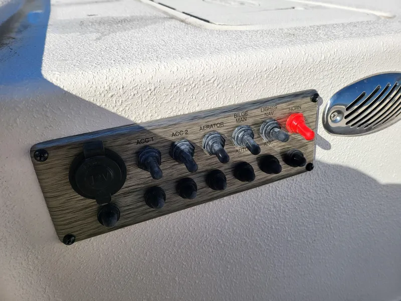 Slide: The Image of Control panel of 2024 Carolina Skiff E16 JVX TH boat with switches and speaker. - 10