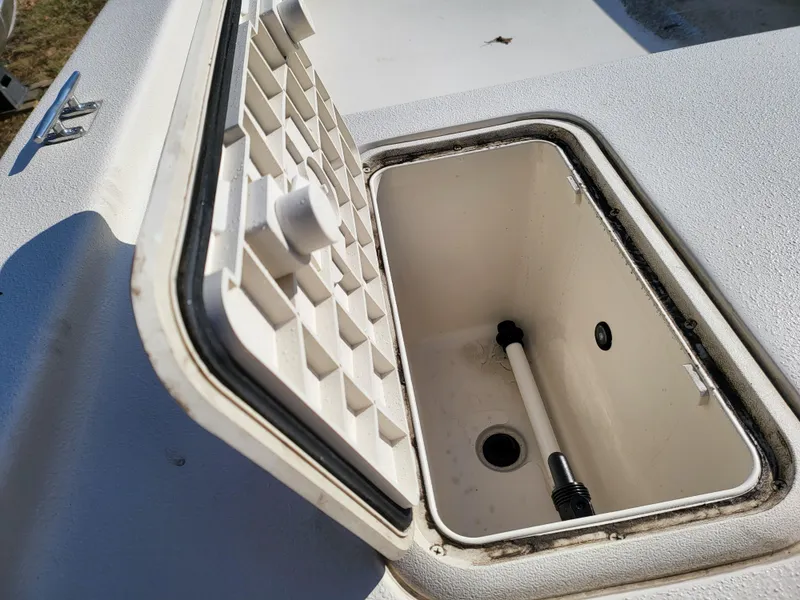 Slide: The Image of 2024 Carolina Skiff E16 JVX TH boat storage compartment with open lid. - 13
