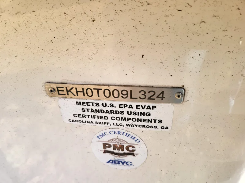 Slide: The Image of 2024 Carolina Skiff E16 JVX TH boat identification plate with EPA compliance sticker. - 18