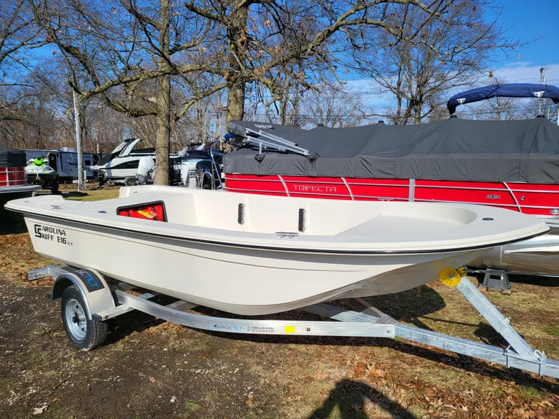 Slide: The Image of 2024 Carolina Skiff E16 JVX TH boat on a trailer in an outdoor setting. - 4