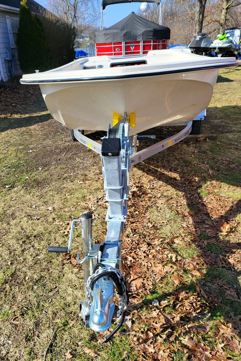 Slide: The Image of 2024 Carolina Skiff E16 JVX TH boat on a trailer in a yard. - 7