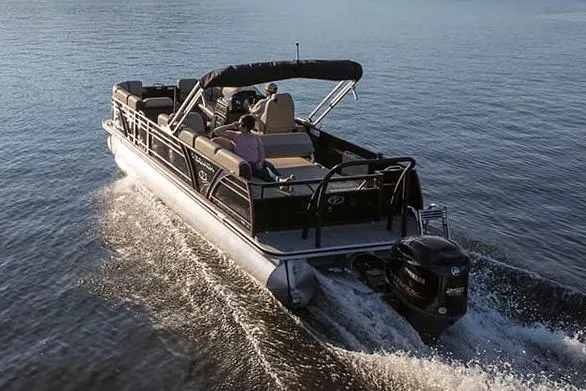 Slide: The Image of 2024 Veranda VP 22VLB pontoon boat in a spacious wooden boathouse. - 2