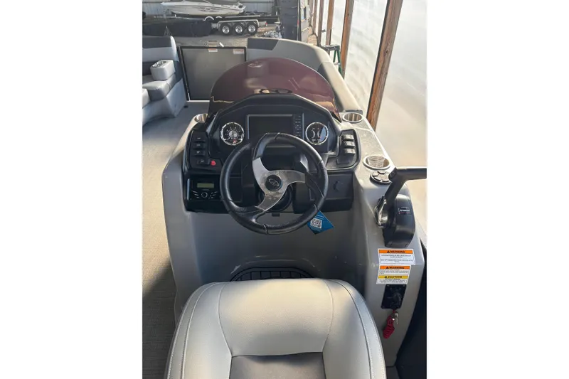 Slide: The Image of 2024 Veranda Relax VR25VLC boat dashboard with steering wheel and controls. - 11