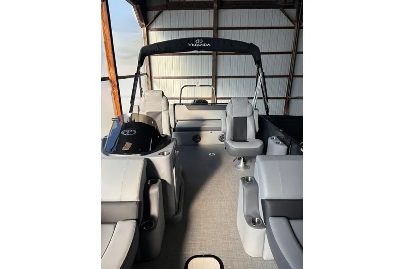 Slide: The Image of 2024 Veranda Relax VR25VLC pontoon boat interior with seating and helm. - 9
