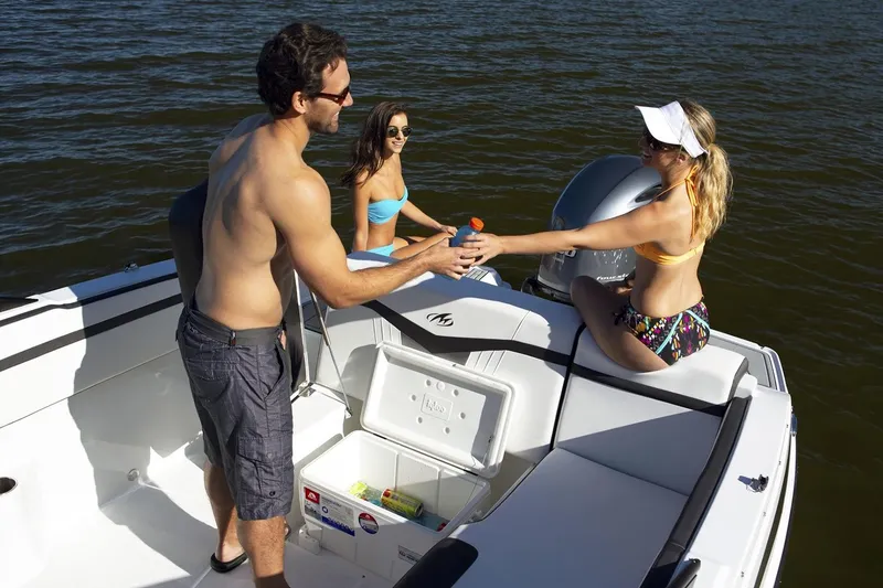 Slide: The Image of 2024 Monterey M-225 boat interior with seating, cup holders, and Mercury engine. - 5