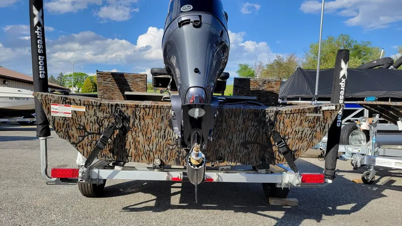 Slide: The Image of 2025 Xpress XP20CC boat with Yamaha Vmax 90 engine on trailer, camo design. - 10
