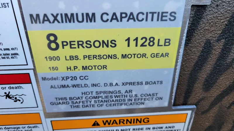Slide: The Image of Capacity label for 2025 Xpress XP20CC boat, 8 persons, 1128 lbs, 150 HP motor. - 12