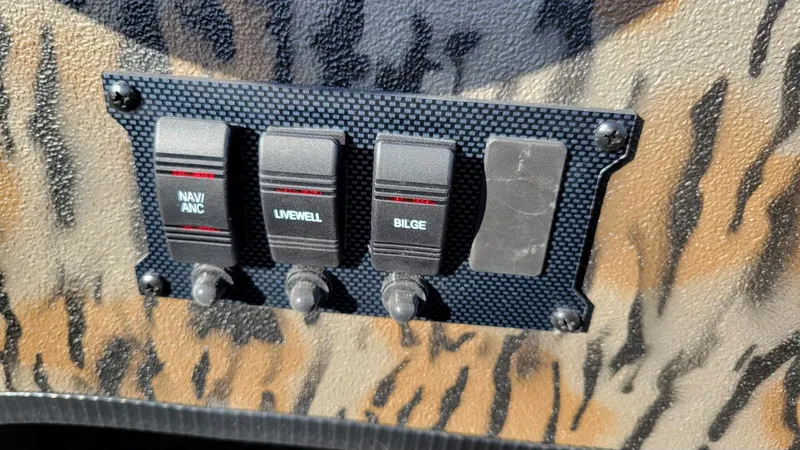 Slide: The Image of Switch panel on 2025 Xpress XP20CC boat with camo background. - 14