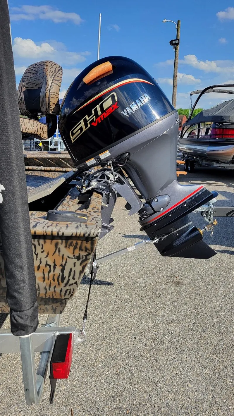 Slide: The Image of 2025 Xpress XP20CC boat with Yamaha Vmax 90 engine, parked outdoors. - 9