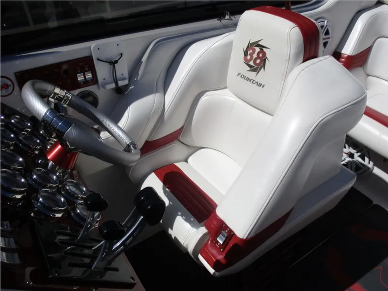 Slide: The Image of 2003 Fountain 38 Lightning boat cockpit with white and red seats and control panel. - 12