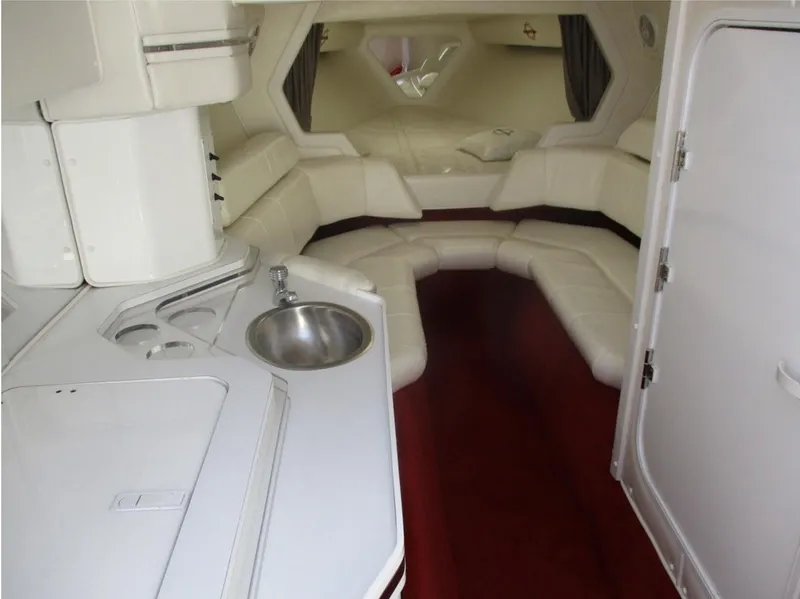 Slide: The Image of 2003 Fountain 38 Lightning boat interior with white leather seating and kitchenette. - 18