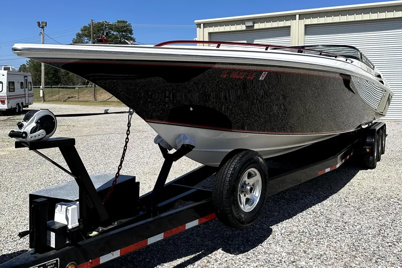 Slide: The Image of 2003 Fountain 38 Lightning speedboat on a trailer in a parking lot. - 4